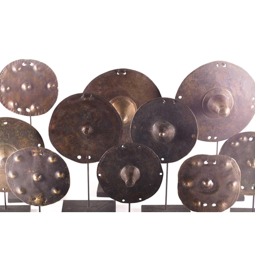 184 - A collection of twelve bronze shield bosses, with embossed or stamped decoration, 10.5cm - 16.5cm di... 