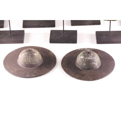 184 - A collection of twelve bronze shield bosses, with embossed or stamped decoration, 10.5cm - 16.5cm di... 