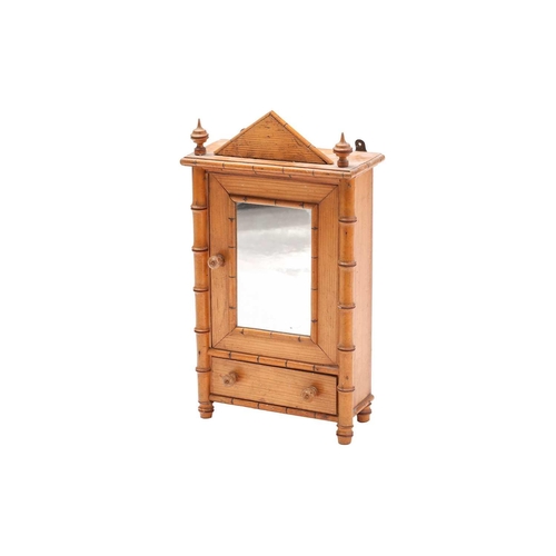 194 - An Aesthetic Movement period faux bamboo and pine miniature mirror door wardrobe with apse and finia... 