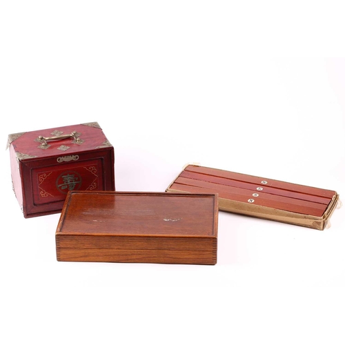 199 - A Chinese early 20th century cased bamboo and bone Mahjong set with tile trays marked for the geogra... 