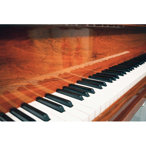 210 - A Steinway of New York baby grand piano No 212527 (1922) with rosewood case. The cast iron inner fra... 