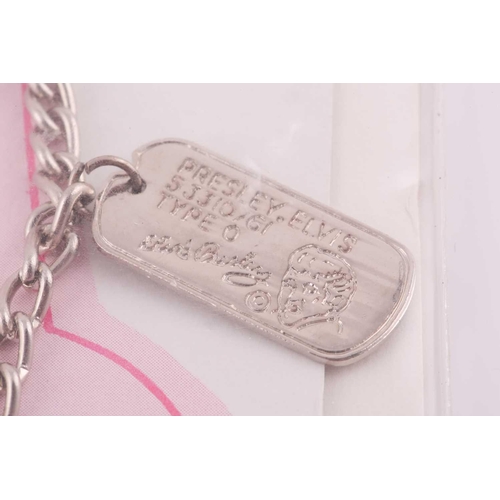 214 - An Elvis Presley Dog Tag bracelet in original packaging and a National Fan Club member badge; The do... 