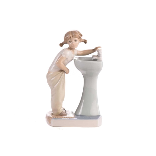 220 - Two Lladro figural table lamp bases, each modelled with a girl holding a basket, 39 cm high, togethe... 