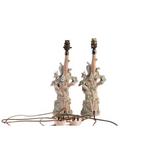 220 - Two Lladro figural table lamp bases, each modelled with a girl holding a basket, 39 cm high, togethe... 