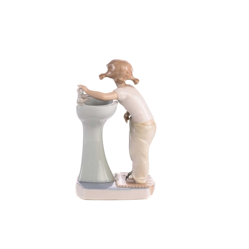 220 - Two Lladro figural table lamp bases, each modelled with a girl holding a basket, 39 cm high, togethe... 