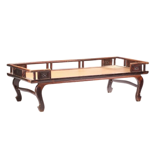 62 - A 19th-century Chinese elmwood opium bed with an open gallery back with lotus flower panel infills a... 