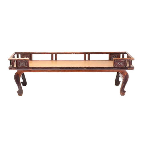 62 - A 19th-century Chinese elmwood opium bed with an open gallery back with lotus flower panel infills a... 