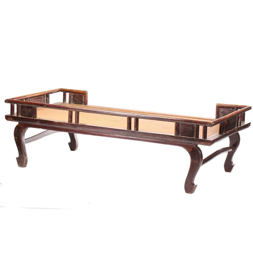 62 - A 19th-century Chinese elmwood opium bed with an open gallery back with lotus flower panel infills a... 