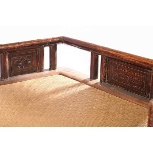 62 - A 19th-century Chinese elmwood opium bed with an open gallery back with lotus flower panel infills a... 