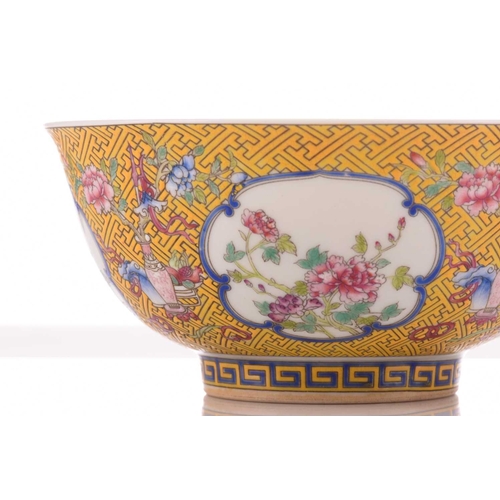 76 - A Chinese porcelain bowl, painted with medallions of auspicious flowers and flanked by treasures, al... 