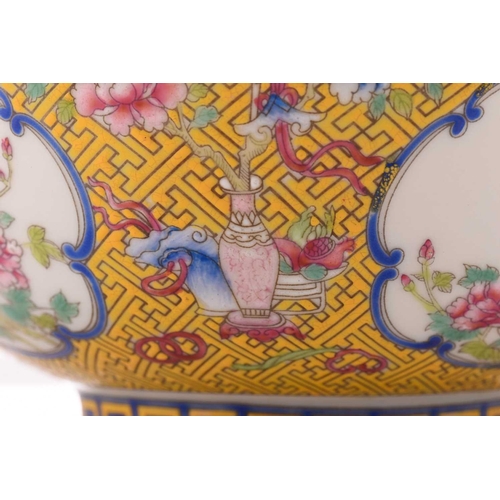 76 - A Chinese porcelain bowl, painted with medallions of auspicious flowers and flanked by treasures, al... 