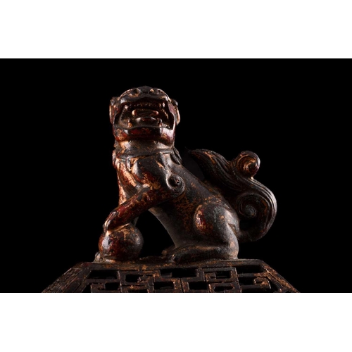 79 - A Chinese bronze censer, of rectangular form, the pierced cover surmounted by a temple lion, the inv... 