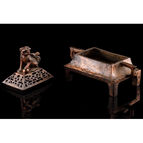 79 - A Chinese bronze censer, of rectangular form, the pierced cover surmounted by a temple lion, the inv... 