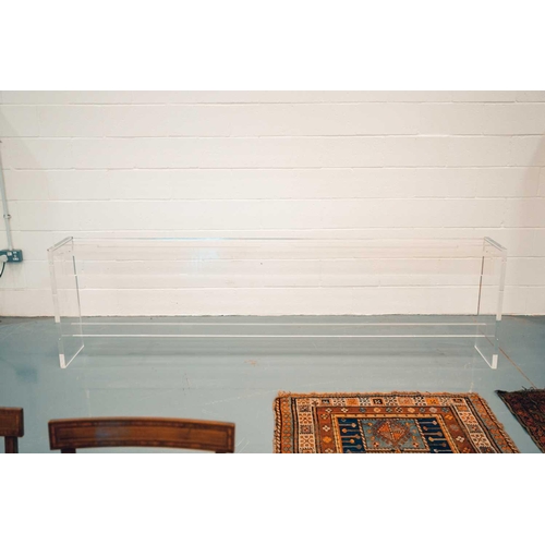 132A - A large vintage lucite console/ side table of plain modernist form with slab ends and a central stre... 