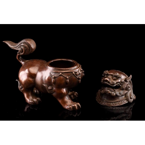 91 - A Chinese bronze censer in the form of a temple lion, with scrolling mane and tail, the chest with p... 