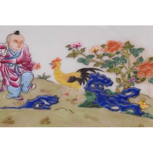 96 - A Chinese porcelain high sided dish, painted with a young boy beside a chicken and chicks between ro... 