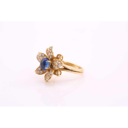 20 - An 18ct gold sapphire and diamond flower ring, comprises an oval sapphire cabochon with a high dome,... 