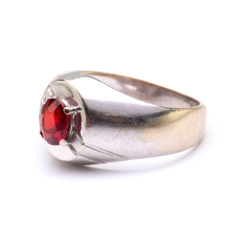 22 - A signet ring set with synthetic ruby, comprises an oval-cut ruby of 5.7 x 4.9 mm claw set on the ri... 