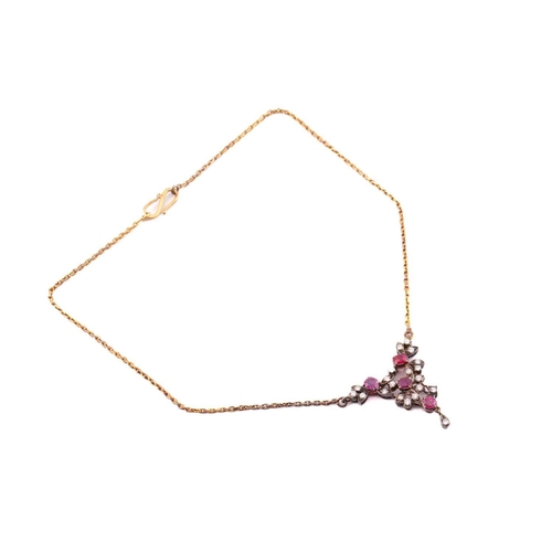 24 - A diamond and ruby necklace, with four round faceted rubies and diamond accents interspersing on mou... 