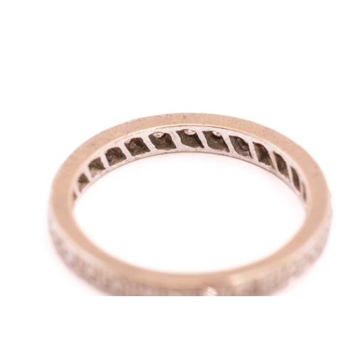 25 - A diamond eternity ring, fully pavé-set with round single-cut diamonds, each approximately measures ... 