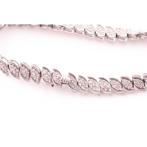 28 - A 9ct gold and diamond line bracelet, with each foliate designed link pavé set with small diamonds, ... 