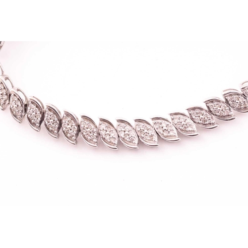 28 - A 9ct gold and diamond line bracelet, with each foliate designed link pavé set with small diamonds, ... 