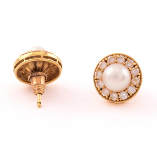 30 - A pair of pearl and diamond earrings in 18ct gold, each consisting of a 7.0 mm round pearl, set with... 