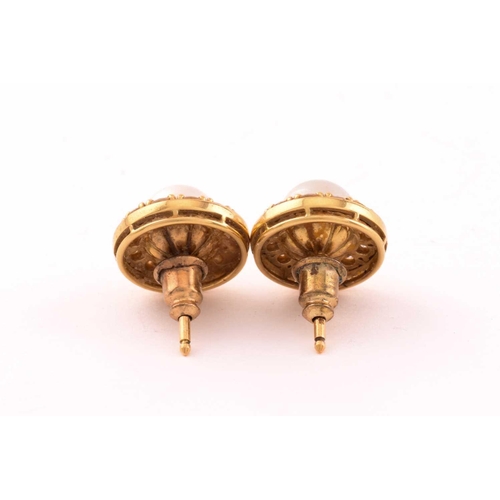 30 - A pair of pearl and diamond earrings in 18ct gold, each consisting of a 7.0 mm round pearl, set with... 