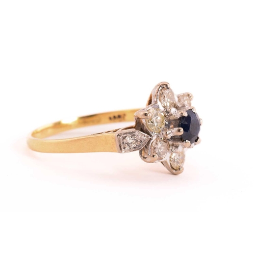 46 - A sapphire and diamond flower head ring in 18ct gold, composed of a central faceted sapphire approxi... 