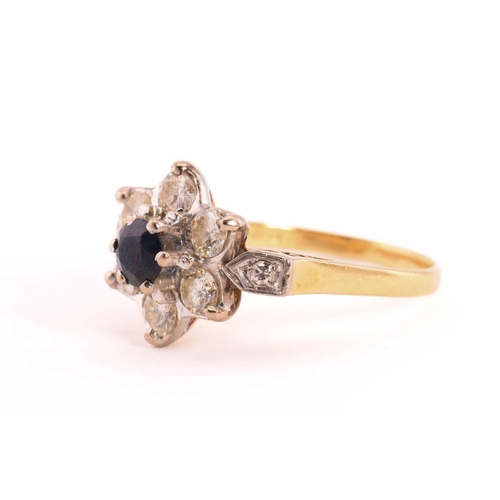 46 - A sapphire and diamond flower head ring in 18ct gold, composed of a central faceted sapphire approxi... 