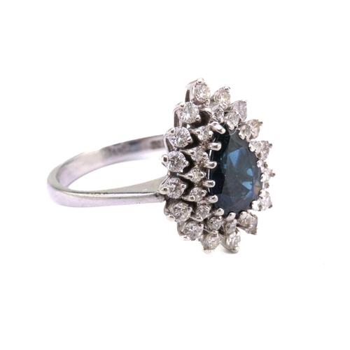 49 - A sapphire and diamond entourage ring, featuring a pear-shaped sapphire in dark blue colour, approxi... 