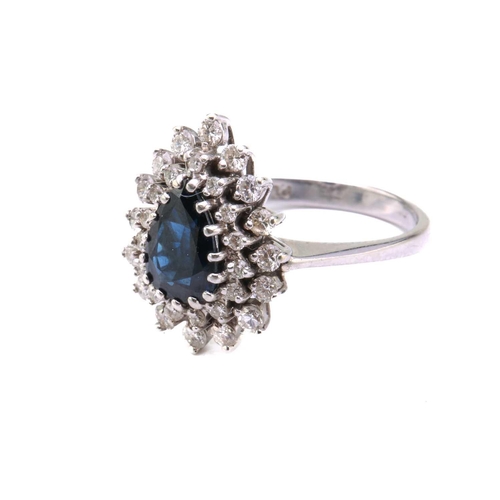 49 - A sapphire and diamond entourage ring, featuring a pear-shaped sapphire in dark blue colour, approxi... 