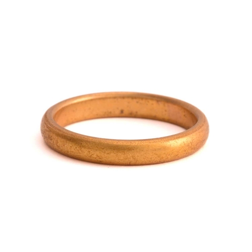 51 - A 22ct gold wedding band and three other rings; The wedding band has a plain court-profile shank, Bi... 