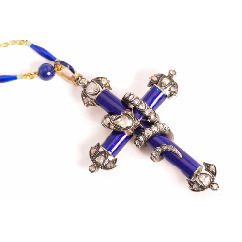 56 - A Victorian enamel cross fleury with a diamond-studded serpent necklace, composed of a cobalt blue e... 