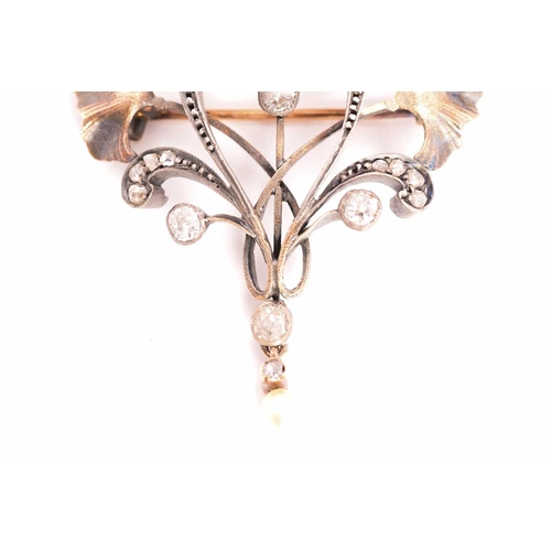 9 - An Art Nouveau diamond and pearl brooch, with rose-cut and old-cut diamonds set in a scrolling mount... 