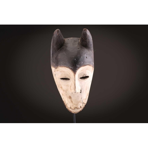 100 - A Lage Bwami society mask, Democratic Republic of Congo, painted in white and earthy pigments28.5cm;... 
