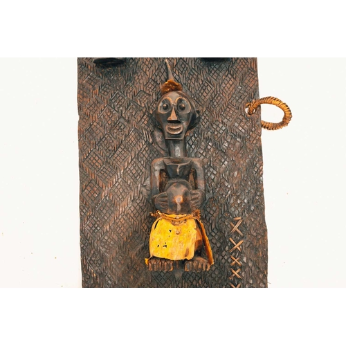 101 - A Songye door, Democratic Republic of Congo, with two relieved carved face masks above a standing (N... 