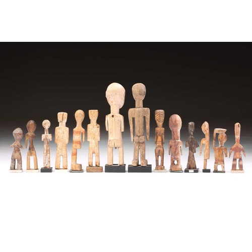 107 - A collection of fourteen Adan/Ewe standing figures, Ghana/Togo/Benin, some painted in coloured pigme... 