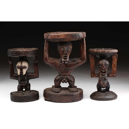 108 - A large Songye double caryatid stool, Democratic Republic of Congo, carved with a standing male and ... 