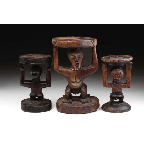 108 - A large Songye double caryatid stool, Democratic Republic of Congo, carved with a standing male and ... 