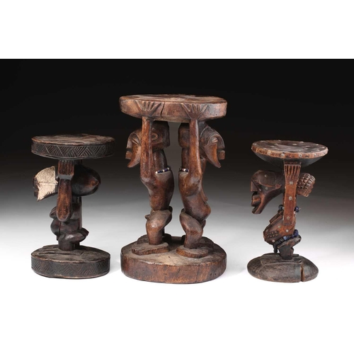 108 - A large Songye double caryatid stool, Democratic Republic of Congo, carved with a standing male and ... 