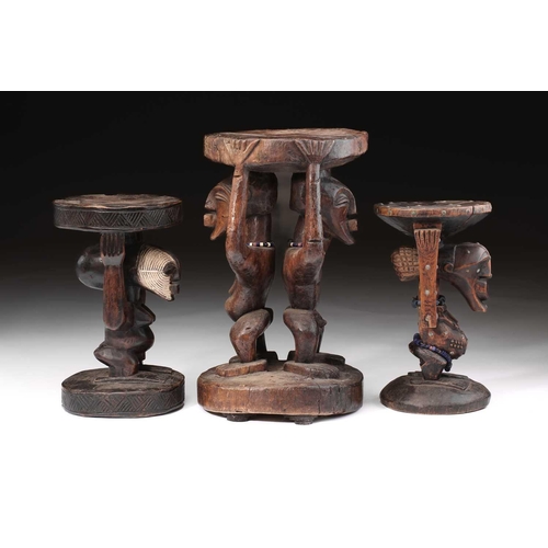 108 - A large Songye double caryatid stool, Democratic Republic of Congo, carved with a standing male and ... 