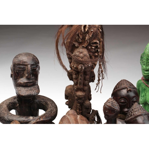 109 - A collection of eighteen principally West African seated and standing figures, to include a Bambara ... 