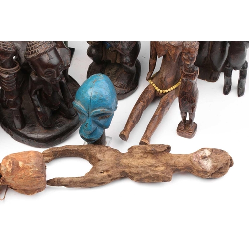 109 - A collection of eighteen principally West African seated and standing figures, to include a Bambara ... 