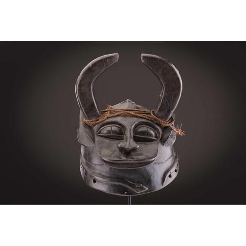 112 - A Mambila zoomorphic headdress mask, Cameroon, covered in animal skin, with wood teeth and red pigme... 
