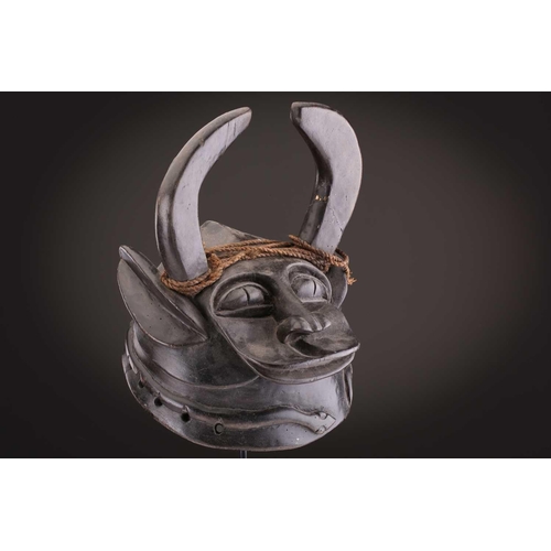 112 - A Mambila zoomorphic headdress mask, Cameroon, covered in animal skin, with wood teeth and red pigme... 