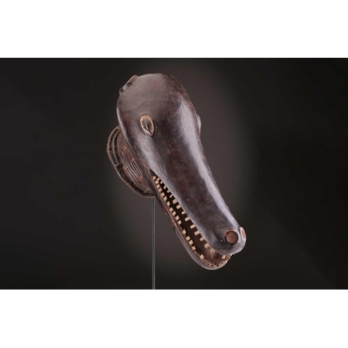 112 - A Mambila zoomorphic headdress mask, Cameroon, covered in animal skin, with wood teeth and red pigme... 