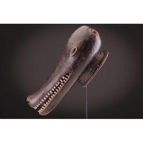 112 - A Mambila zoomorphic headdress mask, Cameroon, covered in animal skin, with wood teeth and red pigme... 