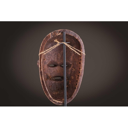118 - A Lombi mask, Democratic Republic of Congo, the eye sockets painted with thick white pigment, 40cm, ... 