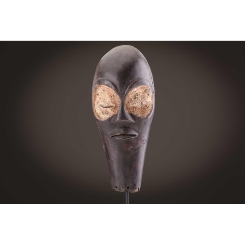 118 - A Lombi mask, Democratic Republic of Congo, the eye sockets painted with thick white pigment, 40cm, ... 